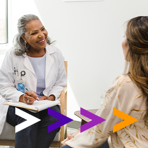 Female doctor talking to middle-aged female patient.